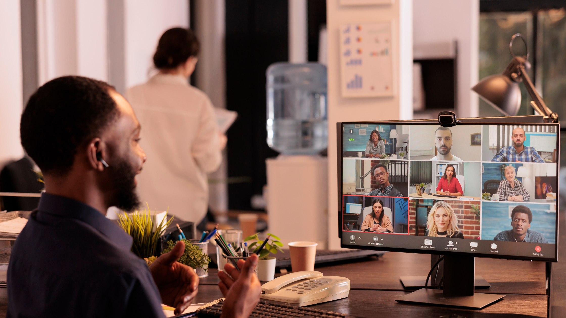 Executive coach guiding a remote team through virtual meeting, supporting leadership development and team collaboration.