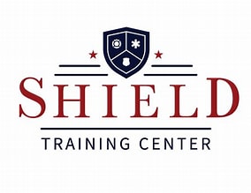 Shield Training Center logo featuring a protective shield emblem with icons and stars above the text.